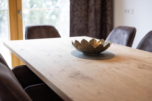 a bowl sitting on top of a wooden table at Alpenhof Chalets in Gerlos