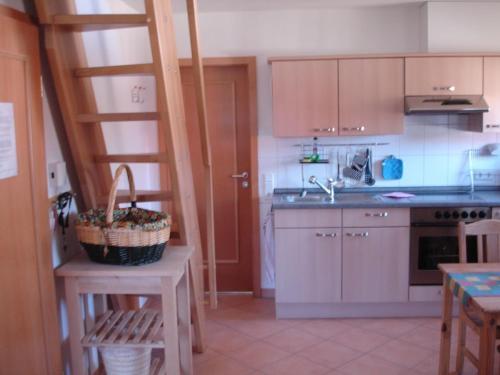 a kitchen with a ladder and a sink and a counter at Ferienwohnung Himmelpfort in Himmelpfort
