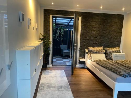 a bedroom with a bed and a door to a patio at Apartment 1 in Neuruppin