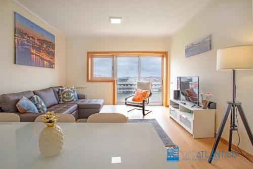 a living room with a couch and a tv at Gaia Panoramic Terrace Apartment - D. Pedro V in Vila Nova de Gaia