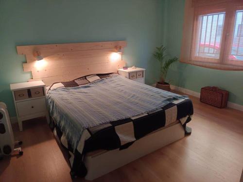 a bedroom with a large bed and two night stands at Hogar con encanto en Segorbe in Segorbe