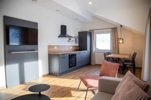 a kitchen and living room with a couch and a table at Das Steinach in Pfronten