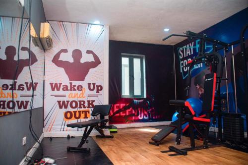 a room with a gym with workout equipment and graffiti at willy's apartment in Lagos