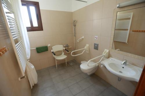 a bathroom with a toilet and a sink at C & A Hotel Apartments in Polis Chrysochous