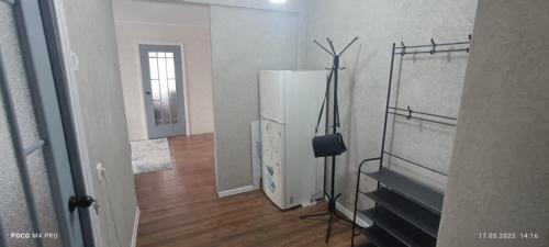 a kitchen with a white refrigerator in a room at LuxHome на УК in Ustʼ-Kamenogorsk