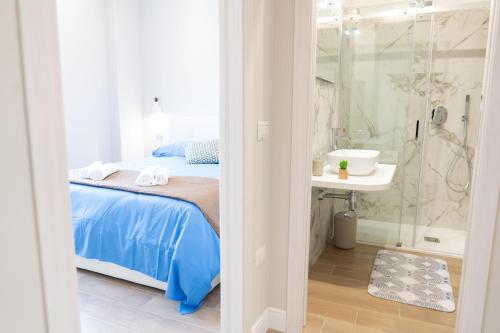 1 dormitorio con cama, ducha y lavamanos en Casa Luna, trilocale a 15 minuti dal mare nel cuore di Cagliari, en Cagliari
