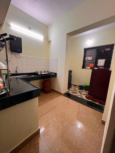 a kitchen with a sink and a counter top at Sri Vidya Palace in Udupi