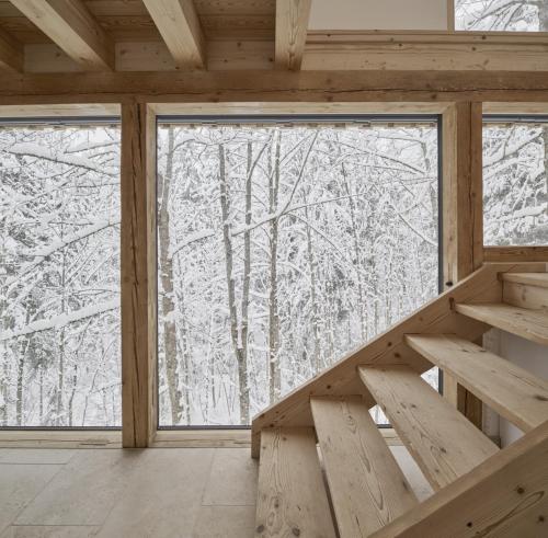 a room with a large window with snow covered trees at Alpeltalhütte in Schönau am Königssee