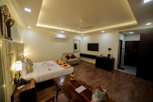 a living room with a couch and a tv at Lake Valley Resort and Spa Tirupati in Tirupati