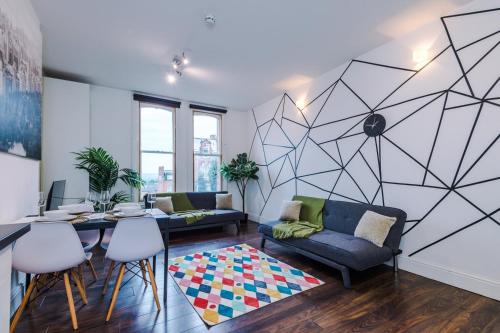 a living room with a couch and a table at Spacious City Centre Retreat in Leeds City Centre in Leeds