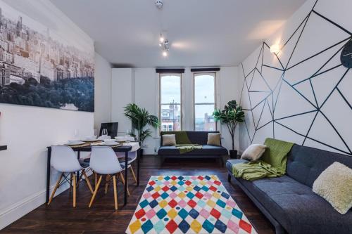 a living room with a couch and a table at Spacious City Centre Retreat in Leeds City Centre in Leeds