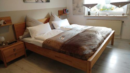 a bedroom with a large bed with white pillows at Eulennest - Elke Spiess in Tarp