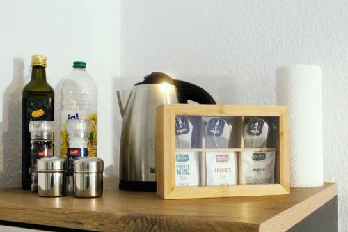 a wooden box sitting on a shelf with bottles of alcohol at NUWILU ONE - Apartment mit Balkon im Herzen Erfurts - Magenta TV- Netflix - Disney in Erfurt