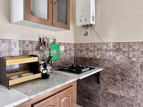 a kitchen with a sink and a stove in it at Dar Zakaria Toursitic Area in Tozeur