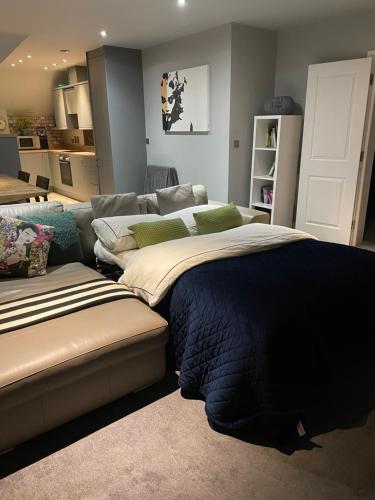 a living room with a bed and a couch at Spacious Apartment NEC BHX in Solihull