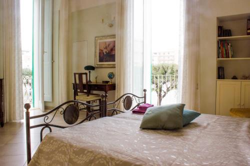 a bedroom with a bed and a large window at Dimora Iride in Monopoli