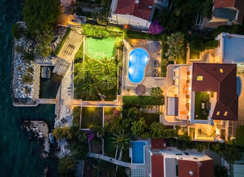 an aerial view of a house with a swimming pool at Luxury Sunset Villa Trogir Private Beach in Okrug Donji