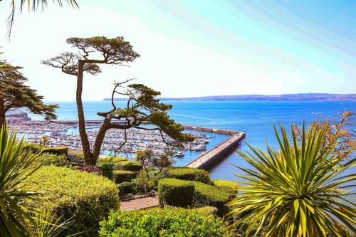 a view of a body of water with a pier at Luxury Riviera View Waterside Apartment in Torquay