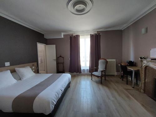 a hotel room with a bed and a desk and a bed and a room at Logis Auberge Des Voyageurs in Vandières