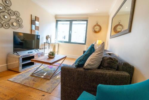 a living room with a couch and a tv at Vibrant Old City 2BR Apartment - Full Kitchen WiFi in Bristol