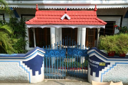a house with a gate and a red roof at DreamCatcher Residency in Cochin