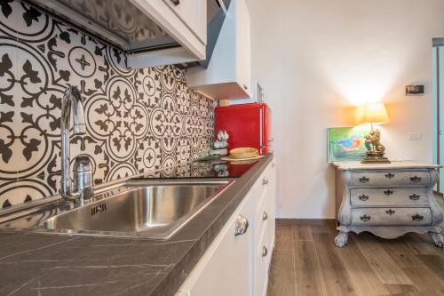 a kitchen with a sink and a red refrigerator at Thousand Dreams Suite in Florence