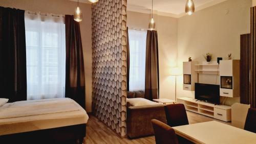 a bedroom with a bed and a living room at Elegance Studios in Vienna