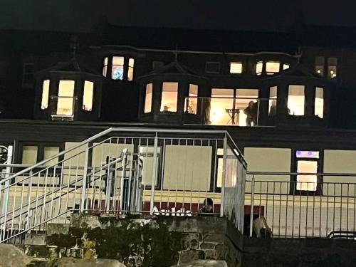 a large building with lights on in the night at The Wheelhouse, Gourock in Gourock