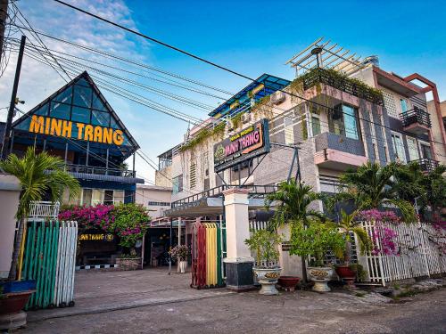 a street with a building with a sign on it at Minh Trang Motel in Chau Doc
