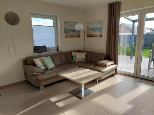 a living room with a couch and a coffee table at Fewo Thaler in Burhave