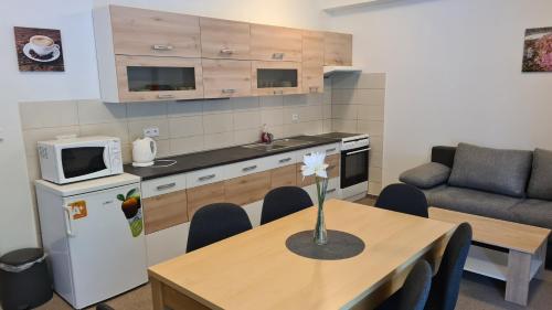 a kitchen with a table with a vase on it at Penzion Dominik in Železná Ruda