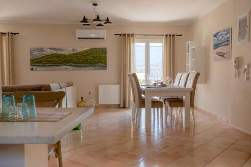 a dining room and living room with a table and chairs at Dina Apartments Argostoli in Argostoli