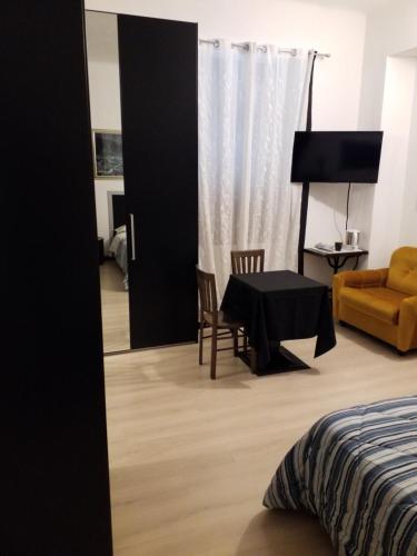 a bedroom with a table and a chair and a couch at Casa Nunzia in Domodossola