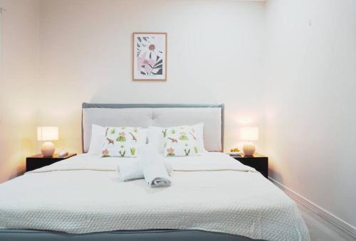 a bedroom with a large white bed with pillows at Entire house in Pimpama in Gold Coast