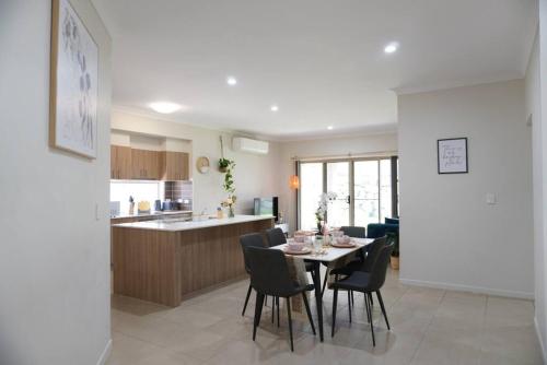 a kitchen and dining room with a table and chairs at Entire house in Pimpama in Gold Coast