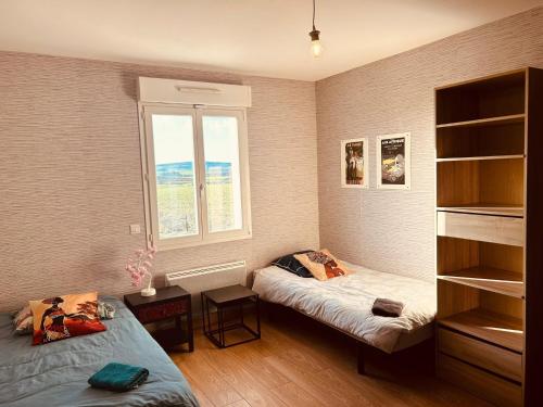 a bedroom with two beds and a window at LA MARIEFACTURE - Comme un Tour du Monde 