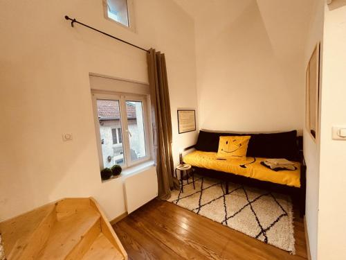 a small bedroom with a bed and a window at LA MARIEFACTURE - Comme un Art de Rire in Belleville