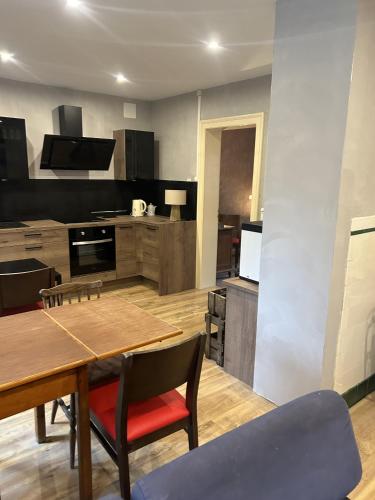 a large kitchen with a wooden table and chairs at LA MARIEFACTURE - Comme du Bon Vin in Sarreguemines