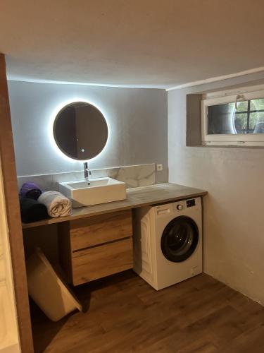 uma casa de banho com um lavatório e uma máquina de lavar roupa em LA MARIEFACTURE - Comme du Bon Vin em Sarreguemines