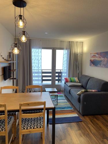 a living room with a couch and a table at Fontanettaz V 014 - MOUNTAIN apartment 4 pers in Veysonnaz
