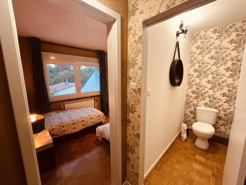 a small bathroom with a toilet and a window at LA MARIEFACTURE - Comme une Fleur 