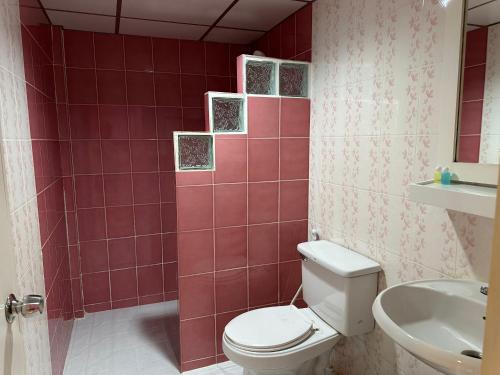 a bathroom with a toilet and a sink at Baan Keang Talay Cha Am in Cha Am