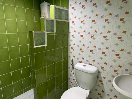 a bathroom with a toilet and a sink at Baan Keang Talay Cha Am in Cha Am