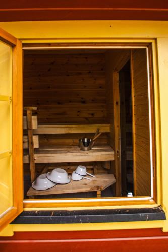a window of a kitchen with a bowl and dishes at Västeräng Glamping in Lillandet