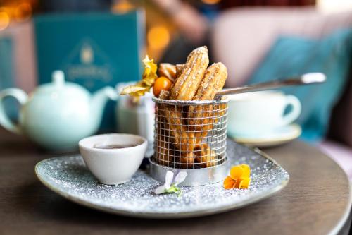 a basket of crackers and a cup of coffee on a table at DoubleTree by Hilton London Victoria in London