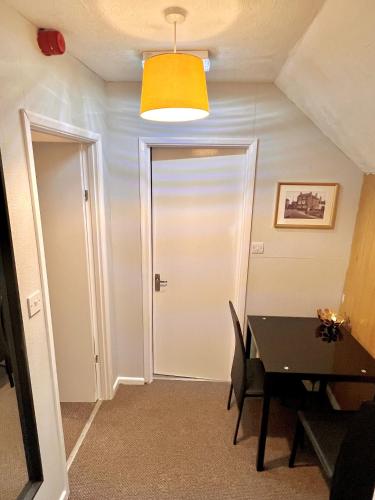 a dining room with a door and a table at The Horse & Jockey in Gainsborough