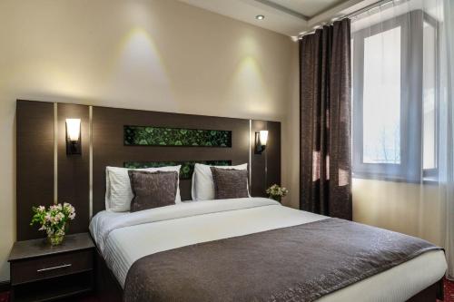 a bedroom with a large bed and a window at Alpina Resort by Stellar Hotels, Tsaghkadzor in Tsaghkadzor