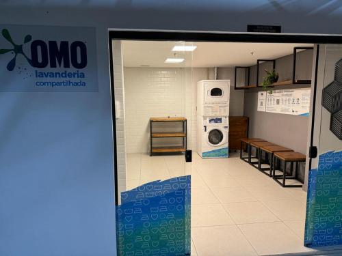 a door to a laundry room with a washing machine at Studio Living Slavieiro Moema in Sao Paulo