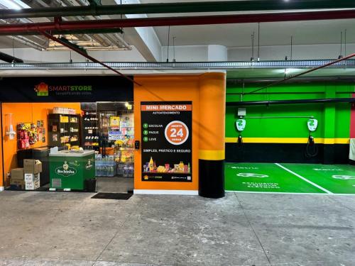 a store with an orange and green wall in a parking garage at Studio Living Slavieiro Moema in Sao Paulo