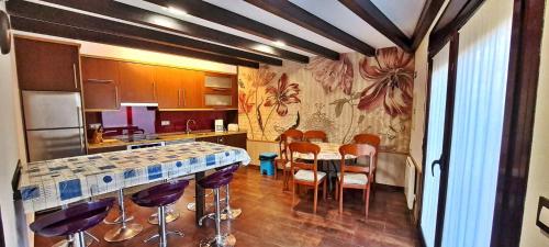 a kitchen with a table and some chairs in it at Casa Monte Toran in Bamiro